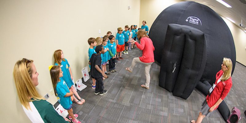 First graders from Lafayette Lower Elementary participate in hands-on physics demonstrations including balloon powered cars, an inflatable planetarium and non-Newtonian fluids at the JAC, all sponsored by the Ole Miss Center for Mathematics & Science Education. Photo by Robert Jordan/Ole Miss Communications